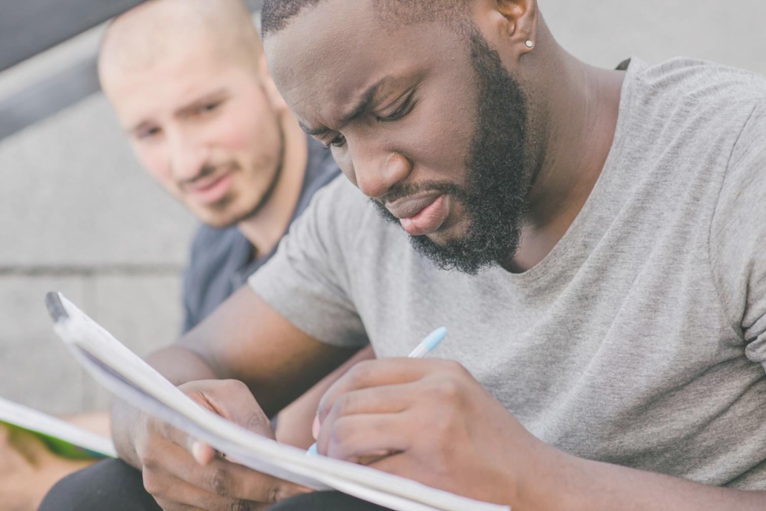 Person reviewing financial documents with calculator and laptop, representing financial planning and stress management