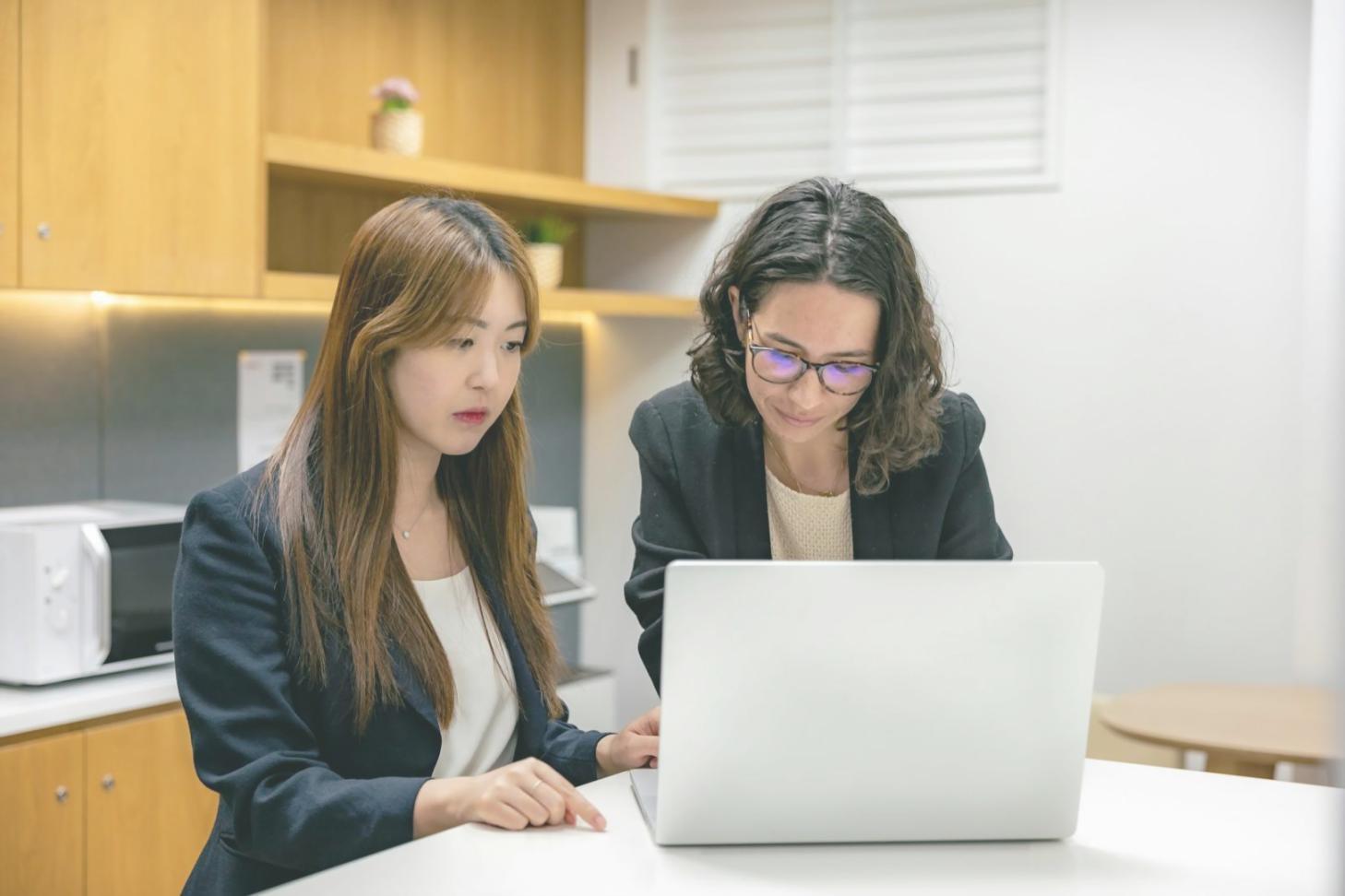 Professional consultation setting with two people discussing financial planning documents across a desk